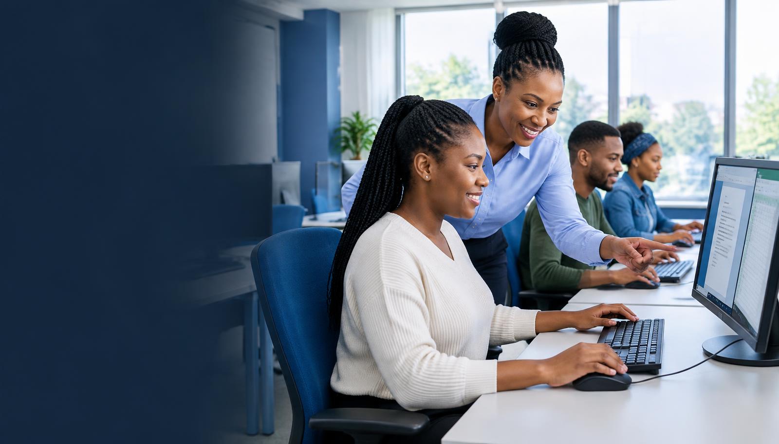 Adult learners practising computer skills with an instructor